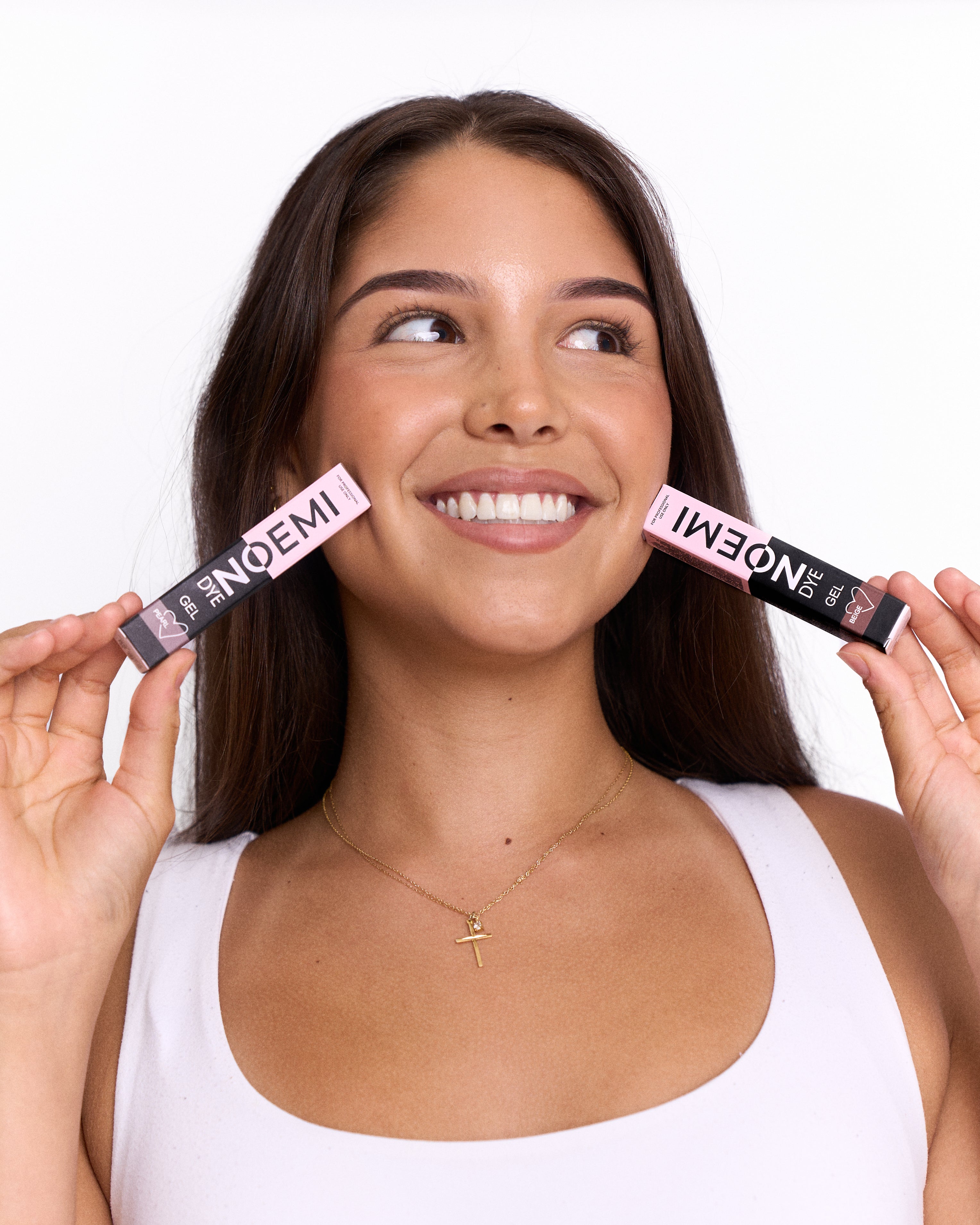 Woman holding two black boxes labeled 'NOEMI' above her face on a white background